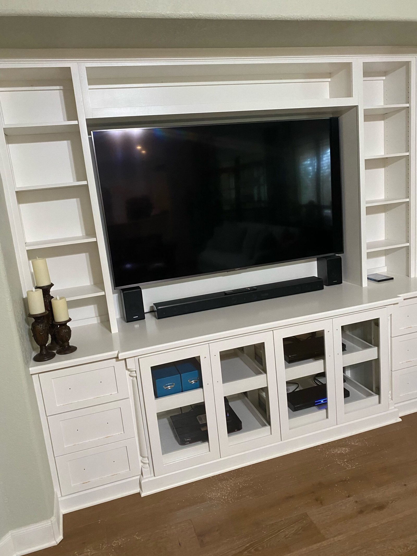 Custom built-in wall unit surrounding television in a bright San Antonio living room