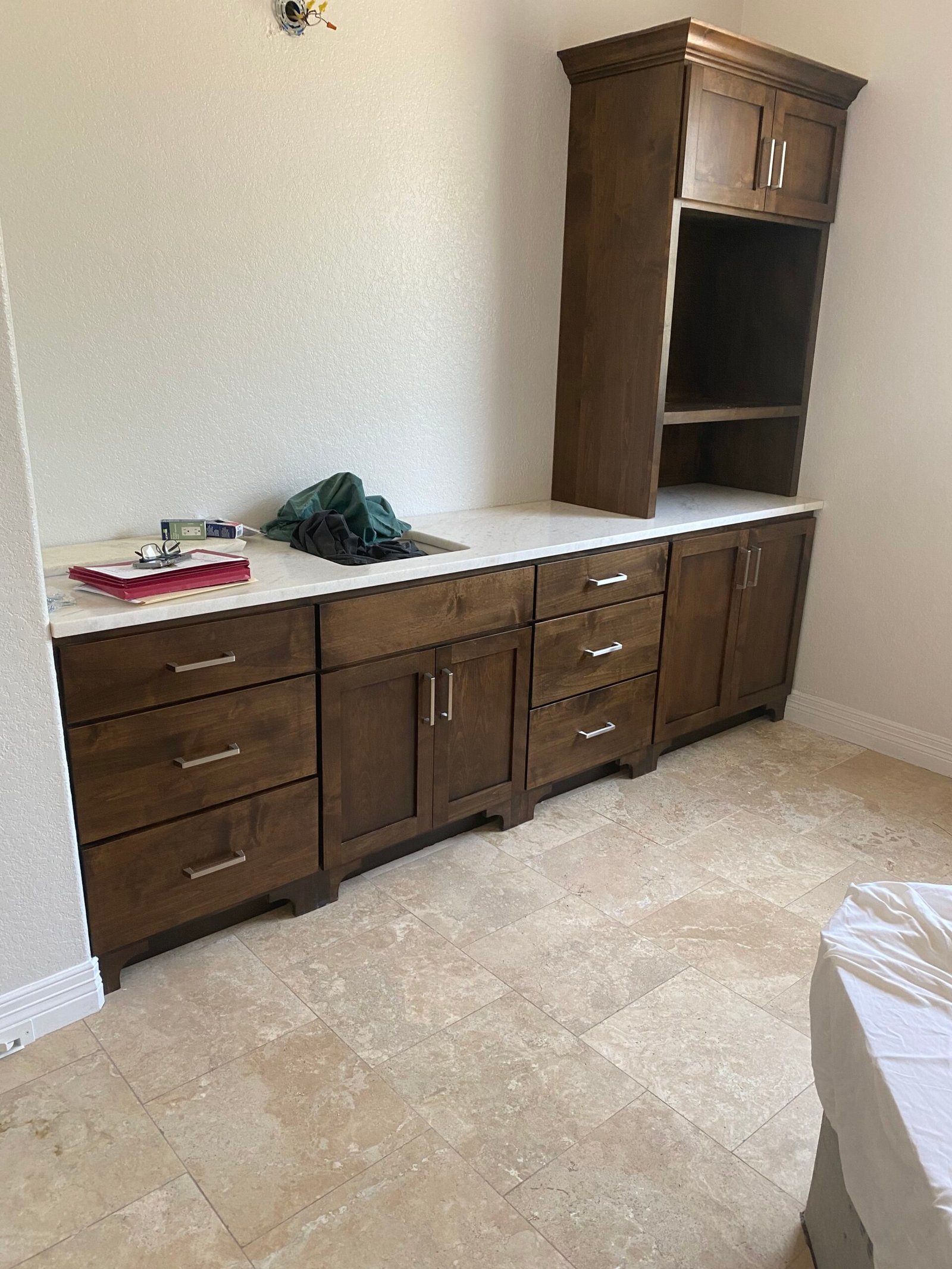 Elegant bathroom vanity cabinets installed beside a bright mirror in a remodeled home